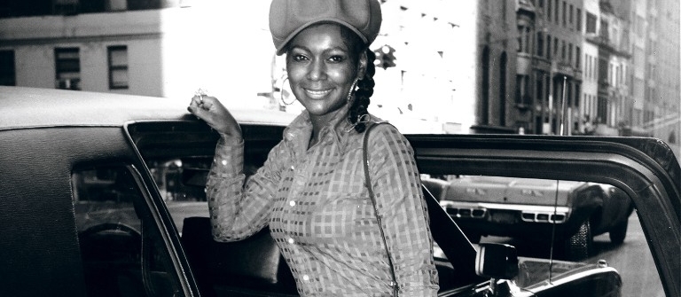 Sylvia Robinson poses next to a car in the 70s